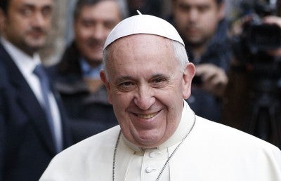 Pope Francis greets people at a General Audience.